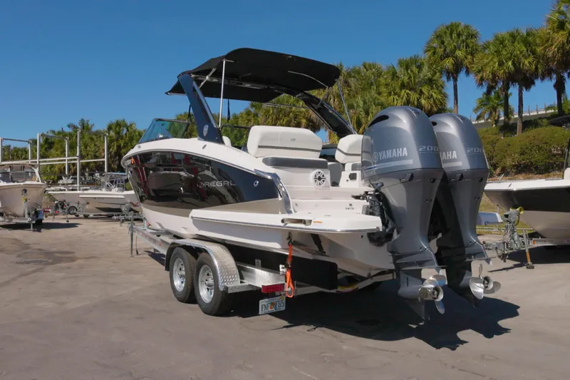  Yacht Photos Pics 2017 Regal 29 OBX boat with dual Yamaha engines on a trailer, surrounded by palm trees.