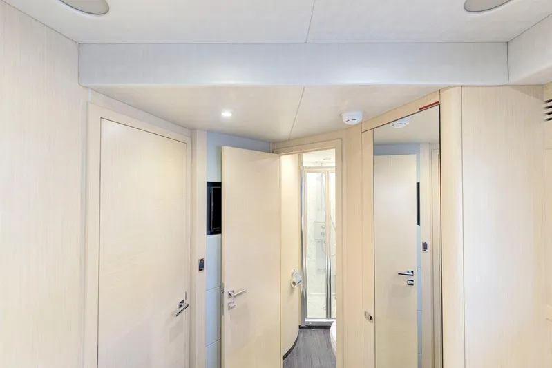 Mojo Risin' Yacht Photos Pics Interior hallway of 2017 Sunseeker 75 Yacht with modern design and light wood finishes.