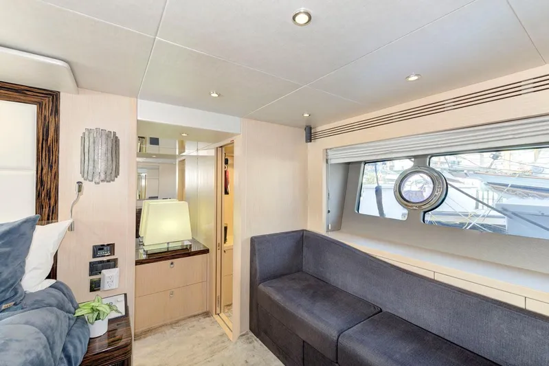 Mojo Risin' Yacht Photos Pics Luxurious interior of 2017 Sunseeker 75 Yacht with modern furnishings and large window.