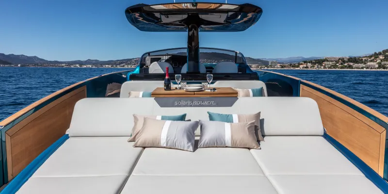  Yacht Photos Pics Luxurious 2024 Solaris Power 48 OPEN yacht with sunbathing area and scenic ocean view.