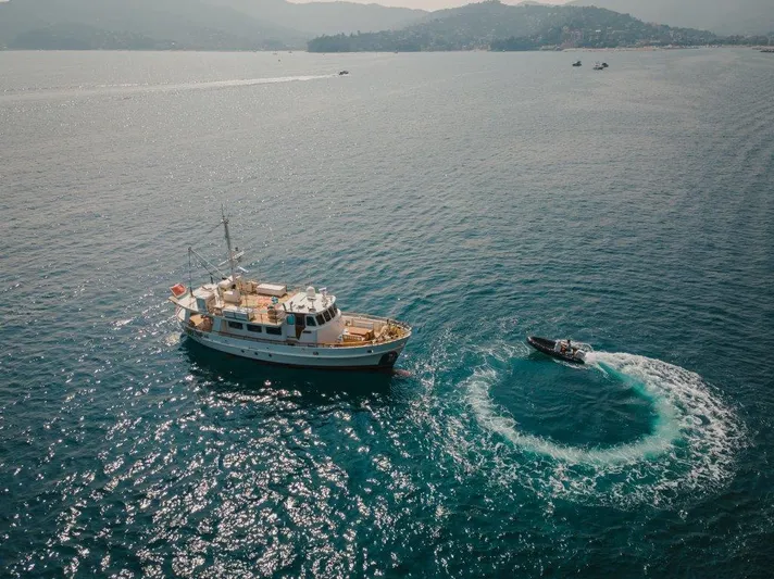 Yona Yacht Photos Pics Aerial view of 1981 Vripack Doggersbank 20 yacht with a small boat circling nearby.