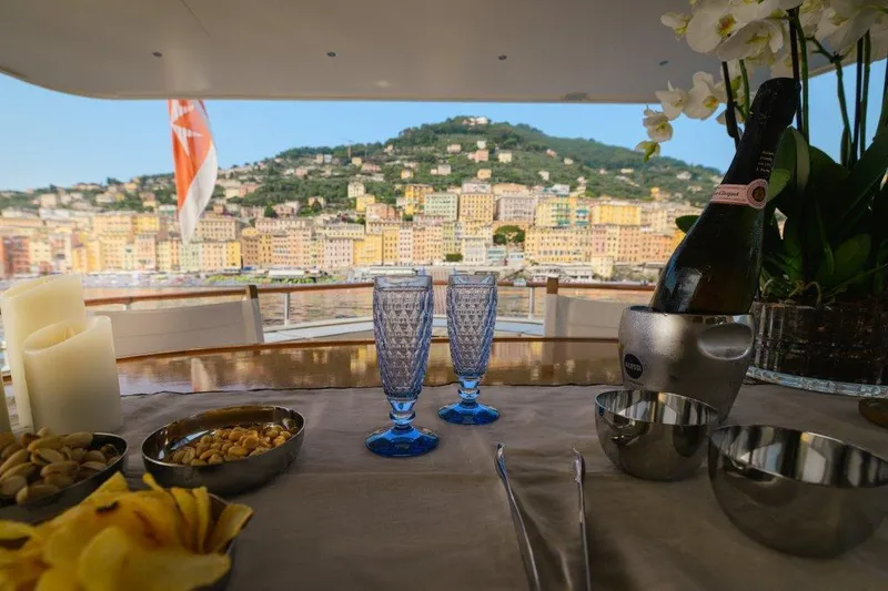 Yona Yacht Photos Pics Luxurious yacht dining setup with champagne, snacks, and coastal view; Vripack Doggersbank 20, 1981.