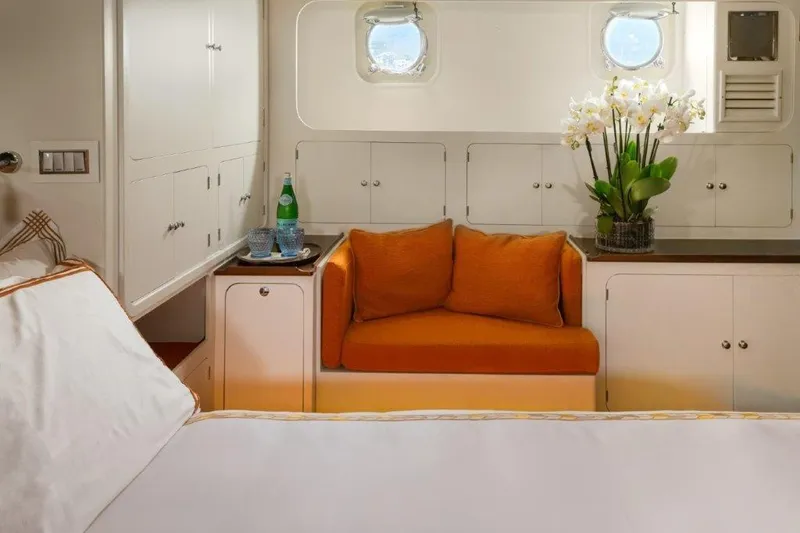 Yona Yacht Photos Pics Luxurious cabin interior of 1981 Vripack Doggersbank 20 yacht with orange seating and elegant decor.