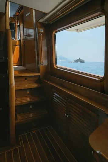 Yona Yacht Photos Pics Interior of 1981 Vripack Doggersbank 20 yacht with wooden stairs and sea view.