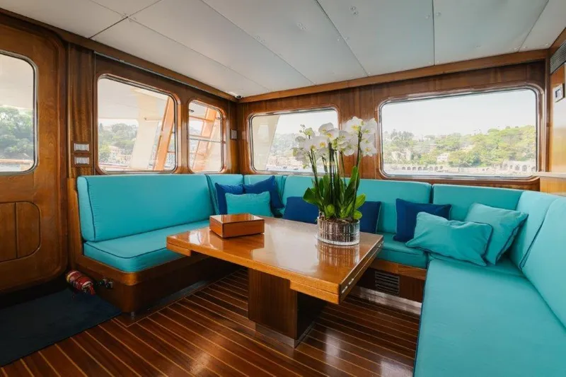 Yona Yacht Photos Pics Luxurious interior of 1981 Vripack Doggersbank 20 yacht with turquoise seating and wooden accents.