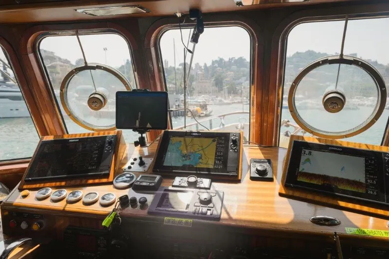 Yona Yacht Photos Pics Bridge of 1981 Vripack Doggersbank 20 yacht with navigation equipment and scenic harbor view.