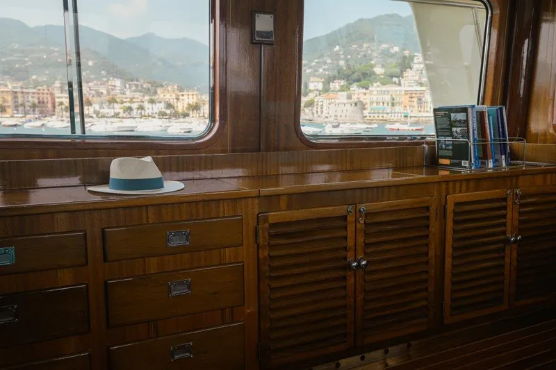 Yona Yacht Photos Pics Interior of 1981 Vripack Doggersbank 20 yacht with wooden cabinetry and scenic window view.