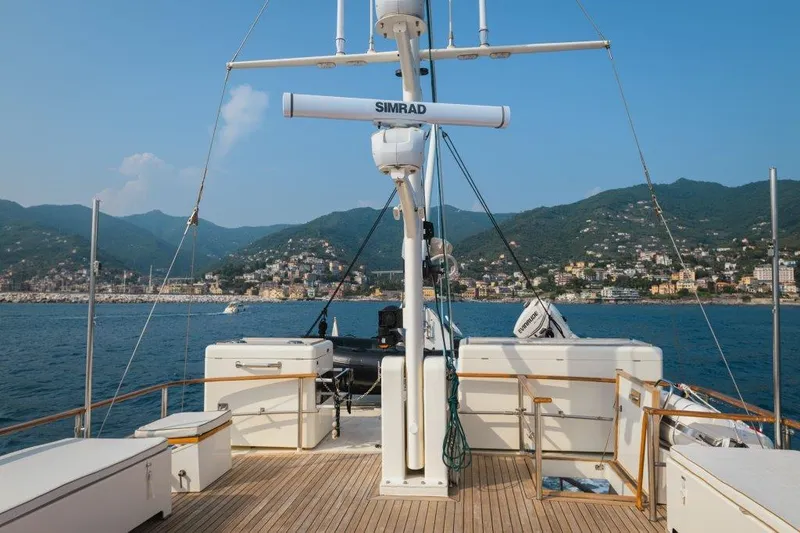 Yona Yacht Photos Pics Deck view of 1981 Vripack Doggersbank 20 yacht with coastal town and mountains in background.
