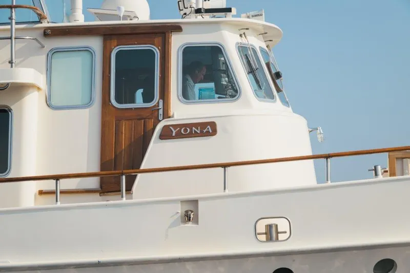 Yona Yacht Photos Pics 1981 Vripack Doggersbank 20 yacht, white exterior, wooden accents, name "Yona" visible.