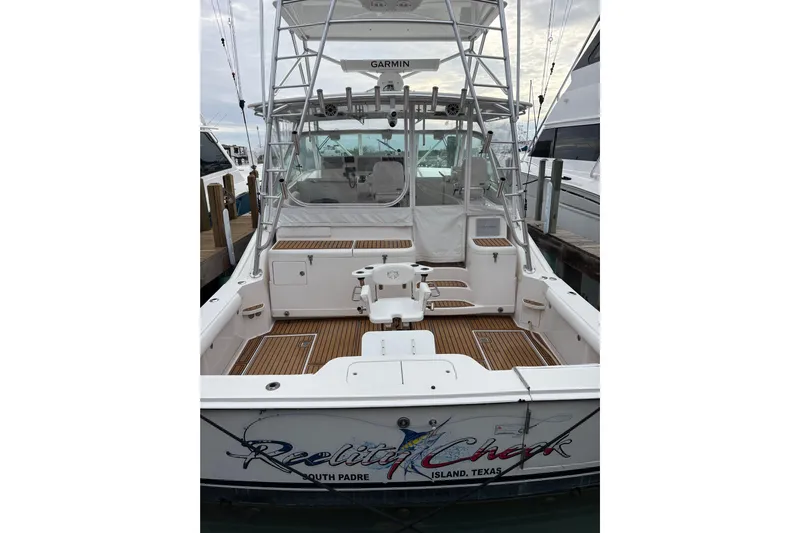 Reelity Check Yacht Photos Pics 2004 Cabo 40 Hardtop Express boat docked, featuring spacious deck and fishing equipment.