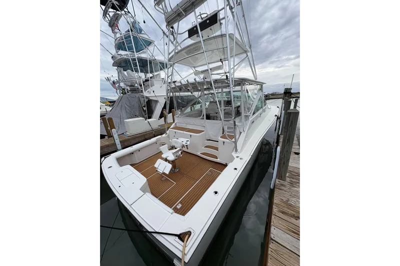 Reelity Check Yacht Photos Pics 2004 Cabo 40 Hardtop Express yacht docked, featuring spacious deck and fishing chair.