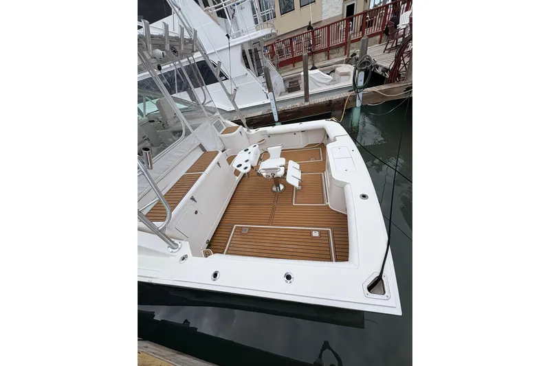 Reelity Check Yacht Photos Pics 2004 Cabo 40 Hardtop Express boat with teak deck, docked at marina.