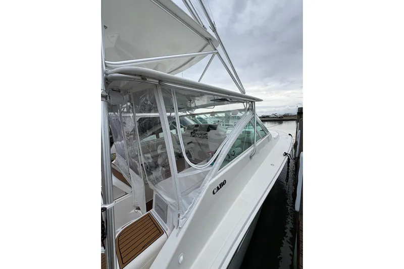 Reelity Check Yacht Photos Pics 2004 Cabo 40 Hardtop Express boat docked, featuring sleek design and clear enclosure.