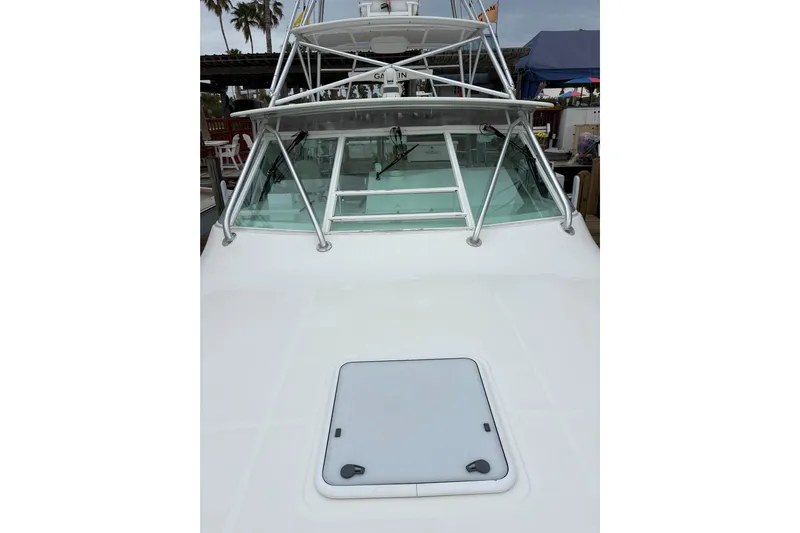 Reelity Check Yacht Photos Pics 2004 Cabo 40 Hardtop Express boat with sleek design and sturdy windshield.
