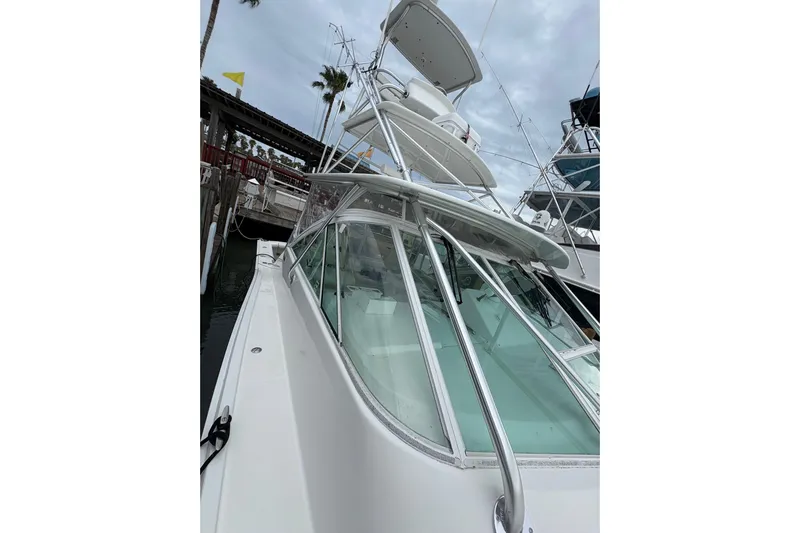 Reelity Check Yacht Photos Pics 2004 Cabo 40 Hardtop Express yacht docked, showcasing sleek design and sturdy construction.