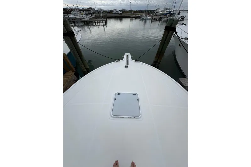 Reelity Check Yacht Photos Pics Bow view of 2004 Cabo 40 Hardtop Express docked at marina.