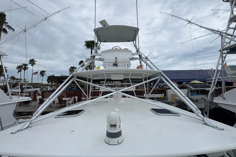 Reelity Check Yacht Photos Pics 2004 Cabo 40 Hardtop Express boat docked, featuring a sleek design and tower structure.