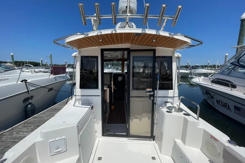  Yacht Photos Pics 2019 Cutwater C-28 boat docked at marina, showcasing rear deck and cabin entrance.
