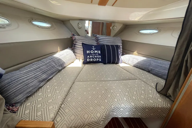  Yacht Photos Pics 2019 Cutwater C-28 cabin interior with cozy bedding and nautical-themed pillows.