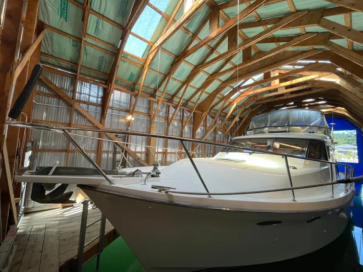 Wind Star Yacht Photos Pics Ocean Alexander 520 Pilothouse 1993 yacht docked in a wooden boathouse.
