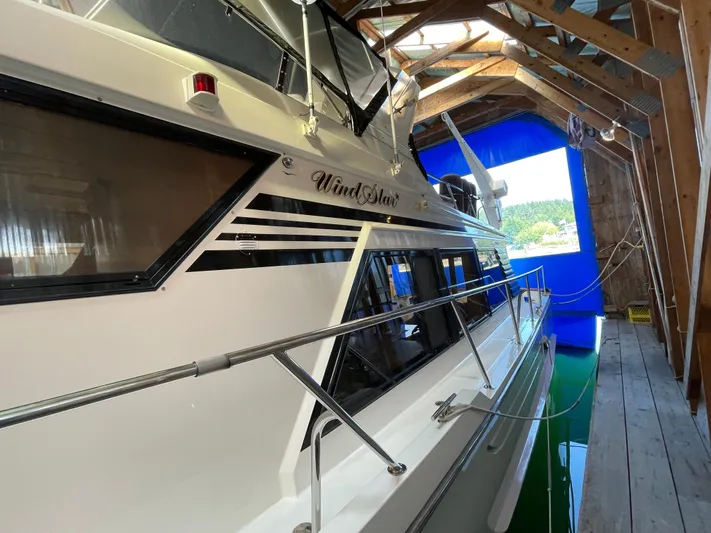 Wind Star Yacht Photos Pics Ocean Alexander 520 Pilothouse 1993 yacht docked in a covered marina.