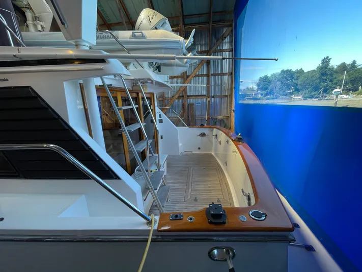 Wind Star Yacht Photos Pics 1993 Ocean Alexander 520 Pilothouse yacht docked indoors with blue backdrop.