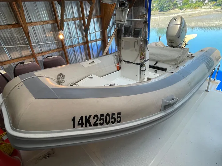 Wind Star Yacht Photos Pics Inflatable boat docked on Ocean Alexander 520 Pilothouse, 1993 model, in a covered marina.