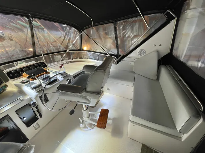 Wind Star Yacht Photos Pics Interior of 1993 Ocean Alexander 520 Pilothouse with helm and seating area.