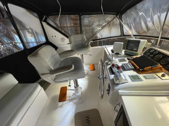 Wind Star Yacht Photos Pics Interior of 1993 Ocean Alexander 520 Pilothouse with helm, seating, and navigation equipment.