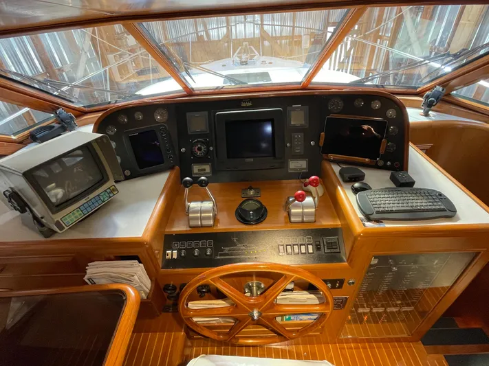 Wind Star Yacht Photos Pics Pilothouse of 1993 Ocean Alexander 520, featuring navigation equipment and wooden steering wheel.