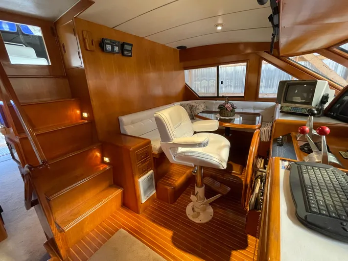 Wind Star Yacht Photos Pics Interior of 1993 Ocean Alexander 520 Pilothouse with wood paneling and seating area.