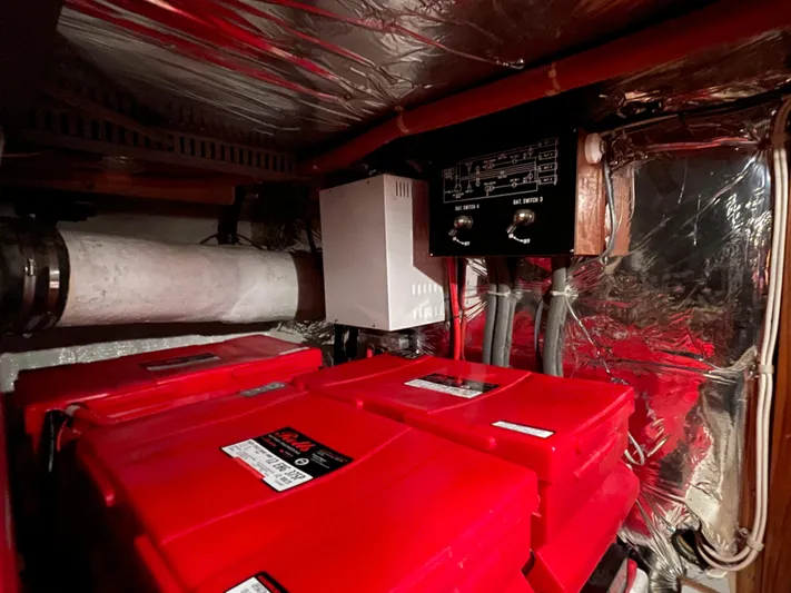 Wind Star Yacht Photos Pics Engine room of 1993 Ocean Alexander 520 Pilothouse with red battery units and control panel.