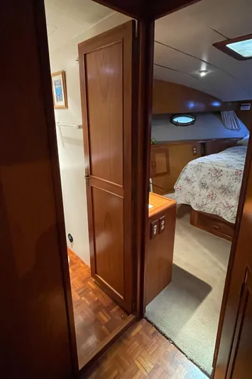Wind Star Yacht Photos Pics Interior view of 1993 Ocean Alexander 520 Pilothouse, featuring a cozy bedroom with wooden accents.