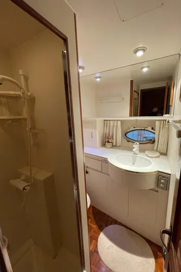 Wind Star Yacht Photos Pics Bathroom interior of 1993 Ocean Alexander 520 Pilothouse yacht, featuring shower and vanity.