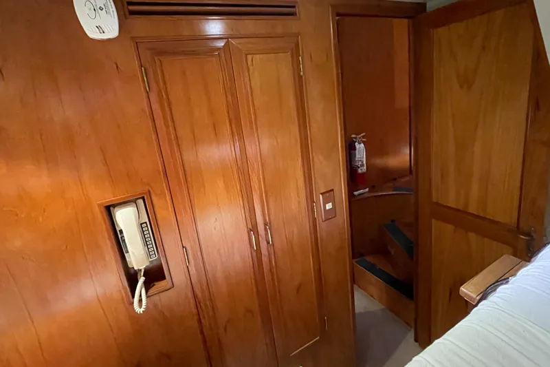 Wind Star Yacht Photos Pics Wood-paneled interior of 1993 Ocean Alexander 520 Pilothouse with phone and closet.