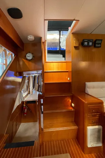 Wind Star Yacht Photos Pics Interior of 1993 Ocean Alexander 520 Pilothouse with wooden stairs and nautical decor.