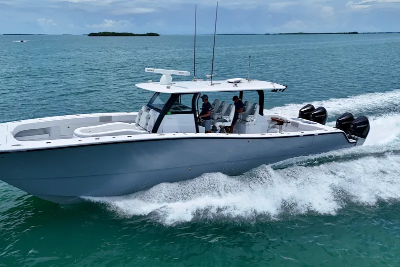  Yacht Photos Pics 2023 Freeman 43 boat cruising on open water with multiple outboard engines.