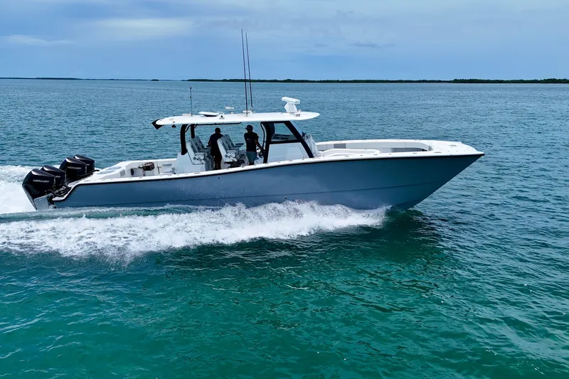  Yacht Photos Pics 2023 Freeman 43 boat cruising on open water with multiple outboard engines.