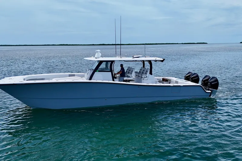  Yacht Photos Pics 2023 Freeman 43 boat on calm water, featuring multiple outboard engines.