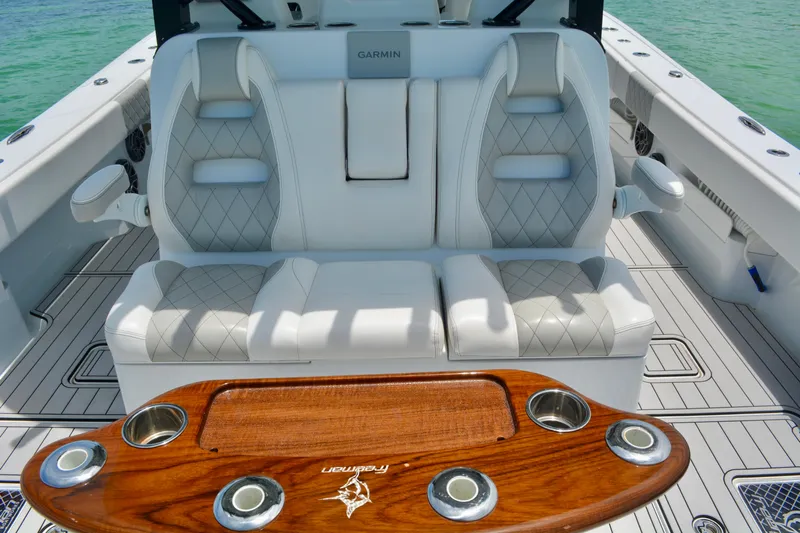  Yacht Photos Pics Luxurious seating on 2023 Freeman 43 boat with elegant wood table and ocean backdrop.