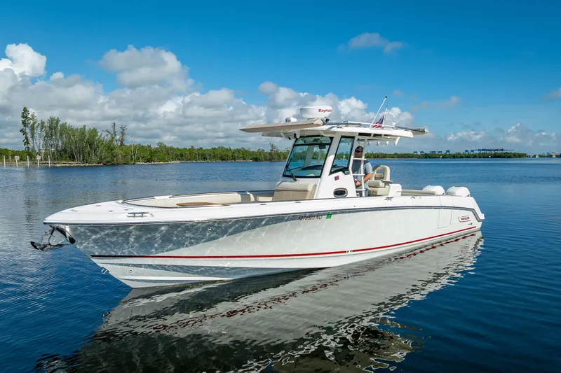 New Seakeeper- 110 Engine Hours- Obo Yacht Photos Pics 2017 Boston Whaler 330 Outrage boat on calm water under blue sky.