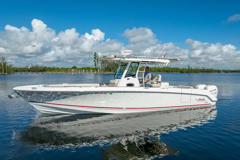 New Seakeeper- 110 Engine Hours- Obo Yacht Photos Pics 2017 Boston Whaler 330 Outrage boat on calm water under blue sky.