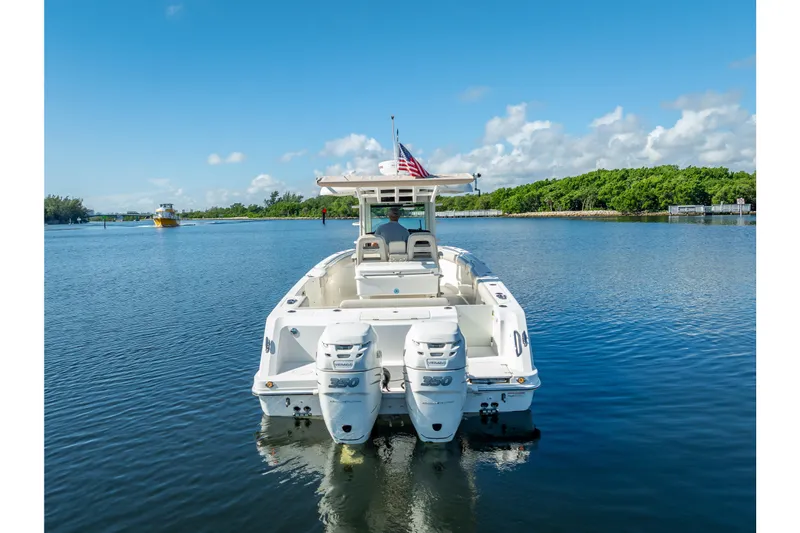 New Seakeeper- 110 Engine Hours- Obo Yacht Photos Pics 2017 Boston Whaler 330 Outrage boat on calm water, rear view with twin engines.