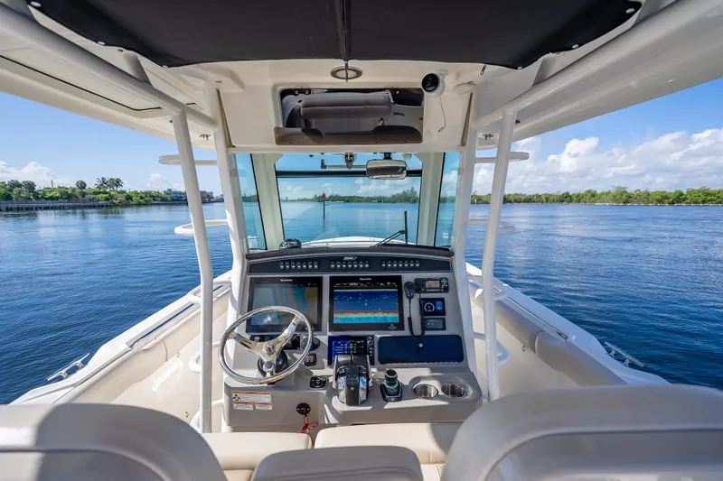 New Seakeeper- 110 Engine Hours- Obo Yacht Photos Pics 2017 Boston Whaler 330 Outrage helm with advanced navigation system on calm waters.