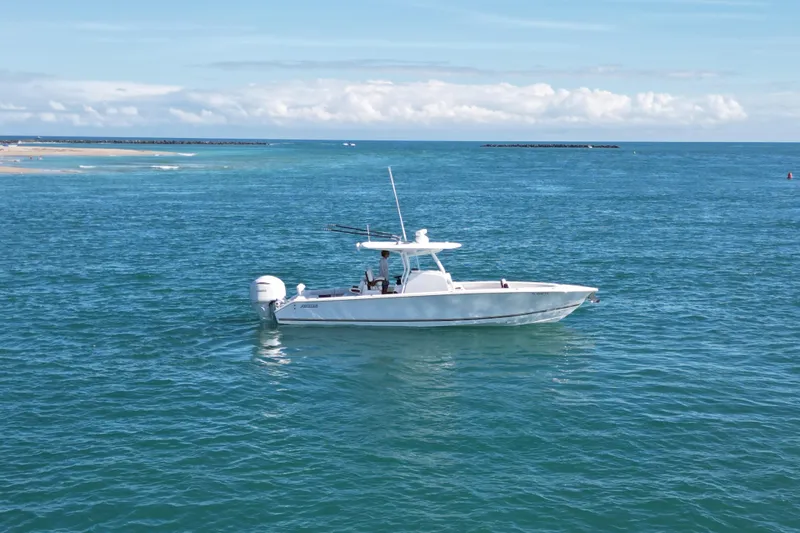 Full Circle Yacht Photos Pics 2025 Jupiter 32 FS boat cruising on open blue ocean under clear sky.