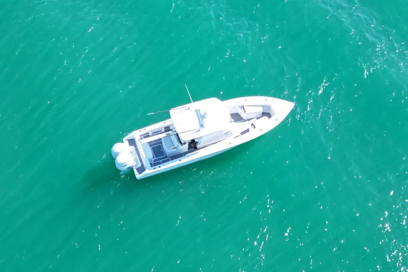 Full Circle Yacht Photos Pics Aerial view of 2025 Jupiter 32 FS boat on turquoise water.