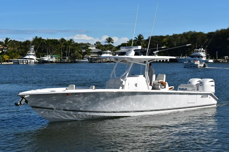 Full Circle Yacht Photos Pics 2025 Jupiter 32 FS boat cruising on a sunny day in a scenic marina.