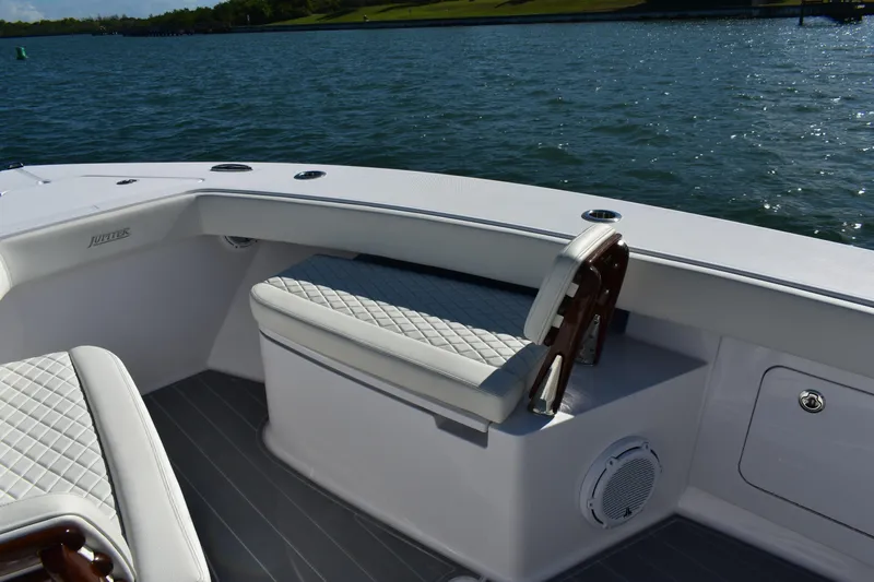 Full Circle Yacht Photos Pics 2025 Jupiter 32 FS boat interior with cushioned seating, on a calm water backdrop.