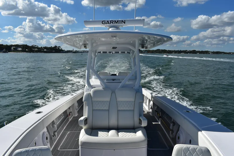 Full Circle Yacht Photos Pics 2025 Jupiter 32 FS boat cruising on open water under a partly cloudy sky.