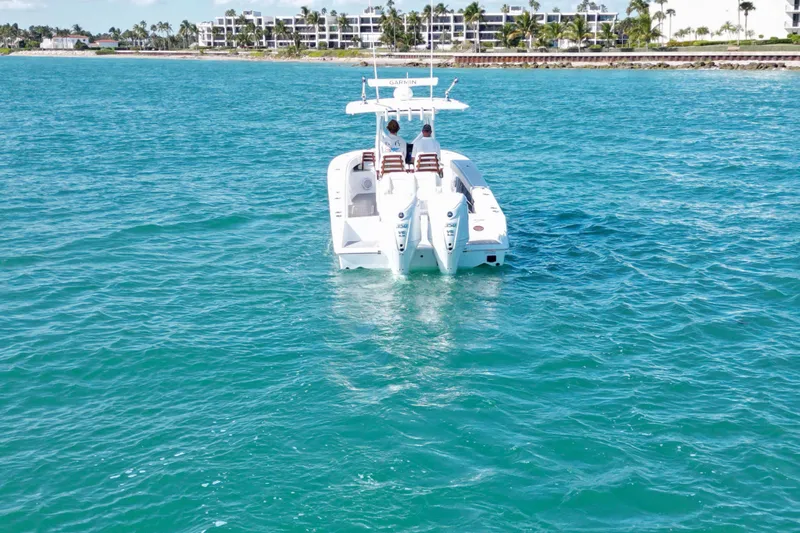 Full Circle Yacht Photos Pics 2025 Jupiter 32 FS boat cruising on clear blue water near a coastal area.